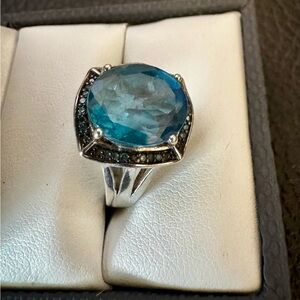 Oval London blue topaz w/blue diamond accent rhodium over sterling silver. Sz 7.